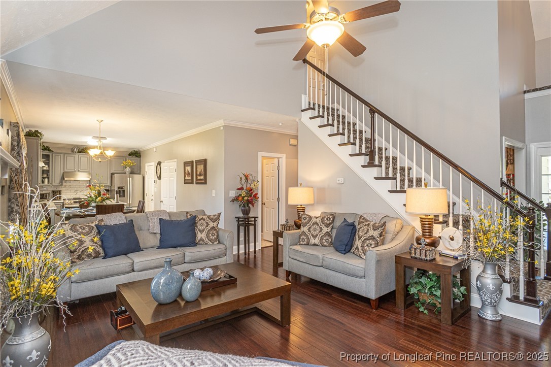 595 Whispering Pines Drive Spring Lake, NC 28390 - Photo 9 of 48 a living room with furniture and a dining table with wooden floor