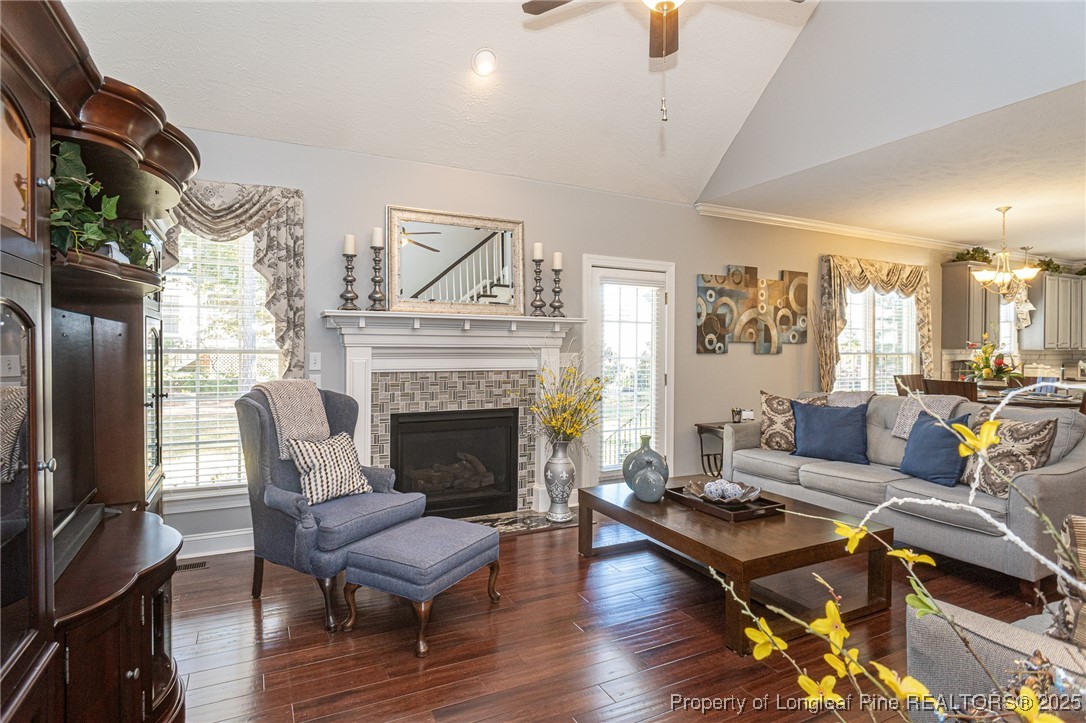 595 Whispering Pines Drive Spring Lake, NC 28390 - Photo 10 of 48 a living room with furniture fireplace and wooden floor