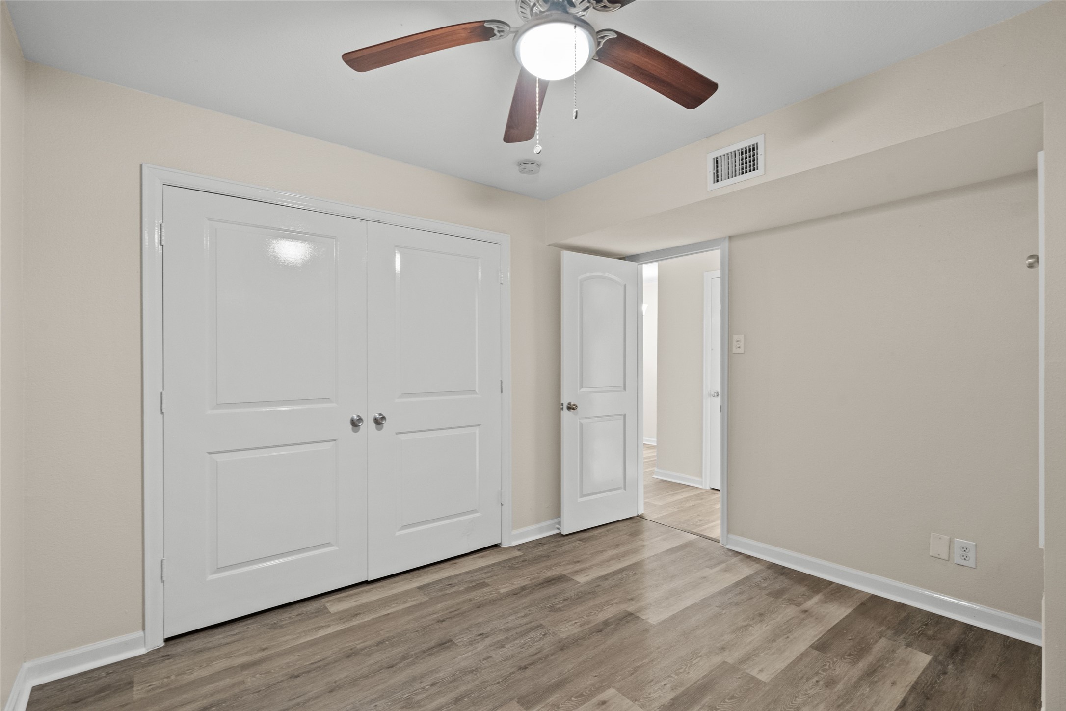102 Strand Street, Unit 3 Galveston, TX 77550 - Photo 11 of 19 wooden floor in an empty room with a window