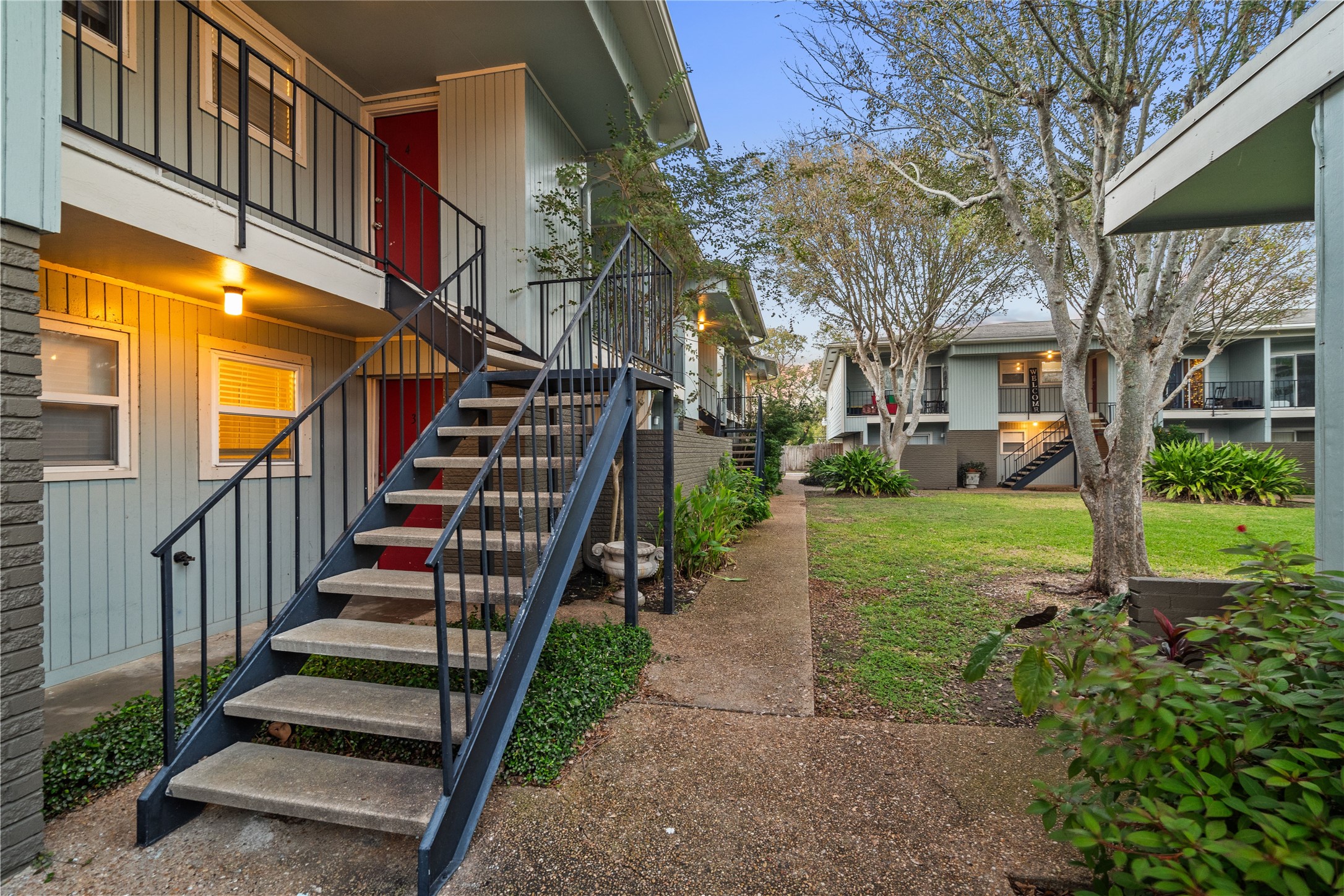 102 Strand Street, Unit 3 Galveston, TX 77550 - Photo 17 of 19 a view of a yard with brick house and a large tree