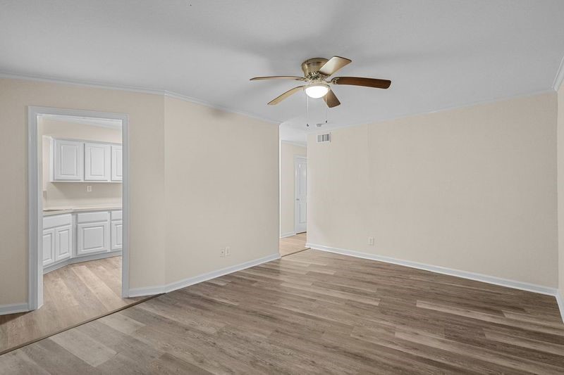 102 Strand Street, Unit 3 Galveston, TX 77550 - Photo 2 of 19 an empty room with wooden floor fan and windows
