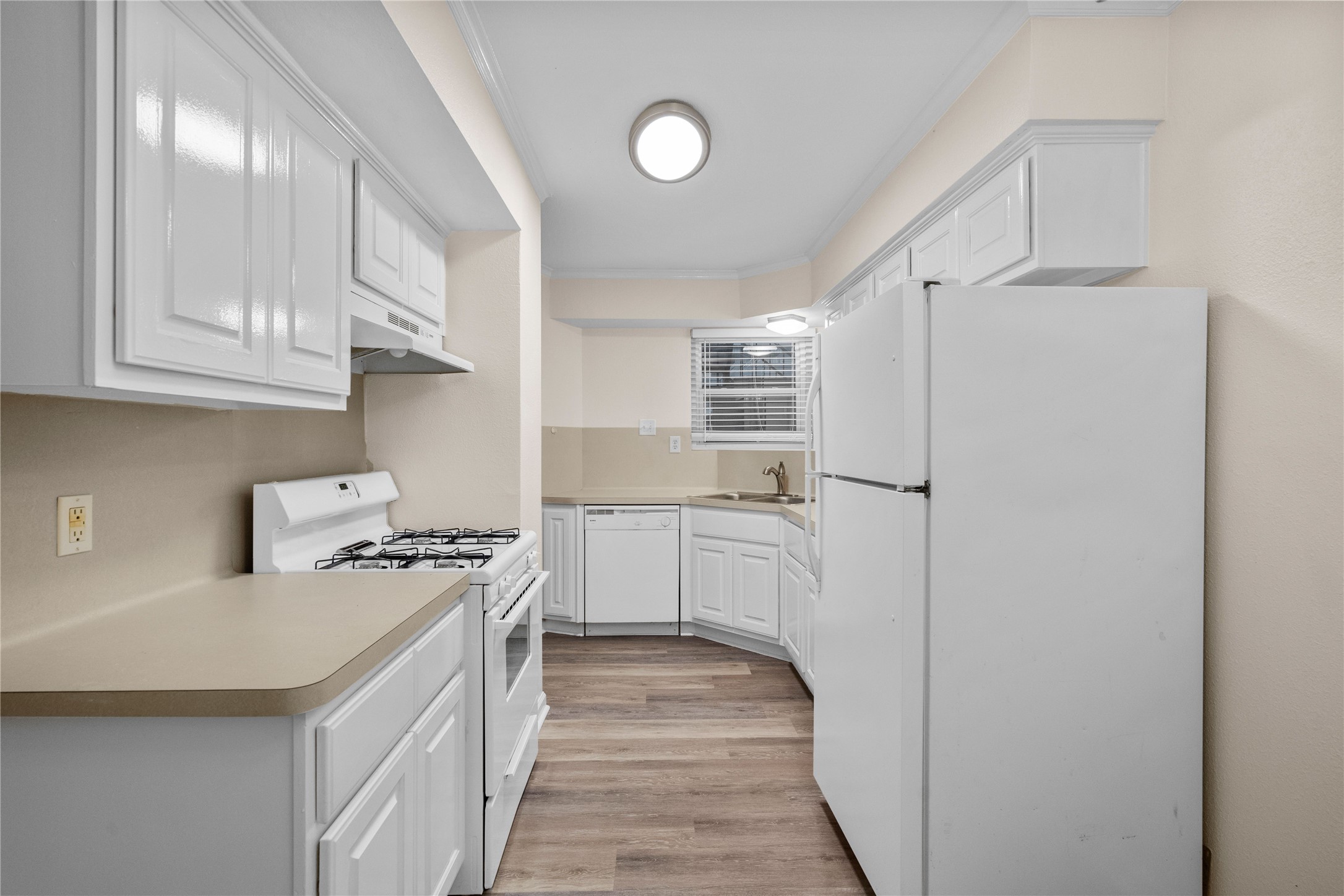 102 Strand Street, Unit 3 Galveston, TX 77550 - Photo 4 of 19 a kitchen with stainless steel appliances a stove refrigerator sink and cabinets
