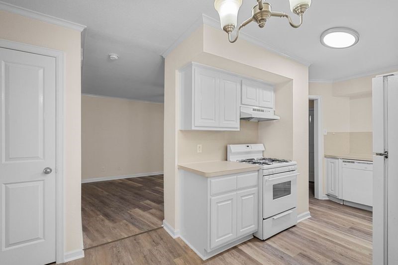 102 Strand Street, Unit 3 Galveston, TX 77550 - Photo 7 of 19 a kitchen with a stove a sink and a refrigerator
