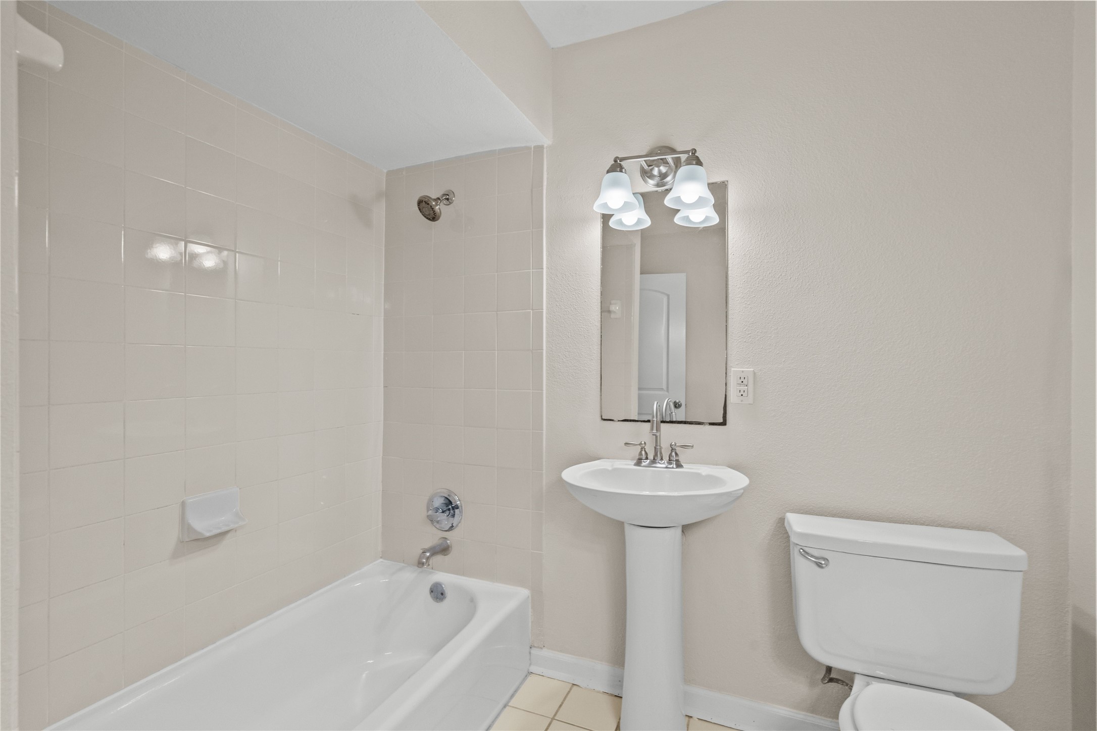 102 Strand Street, Unit 3 Galveston, TX 77550 - Photo 9 of 19 a bathroom with a sink bathtub and a toilet