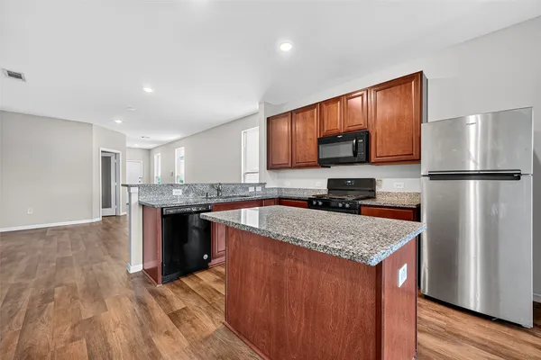 a kitchen with a refrigerator sink and microwave