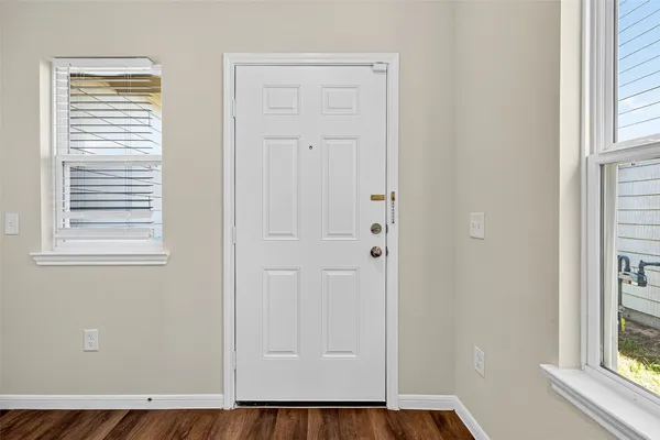 a view of front door with wooden floor