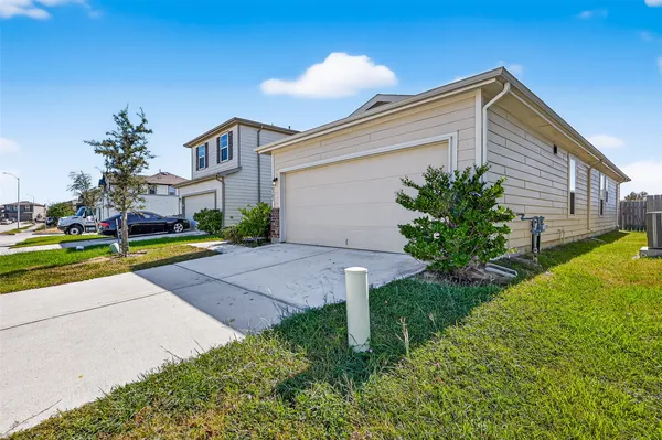 a front view of a house with a yard and potted plants