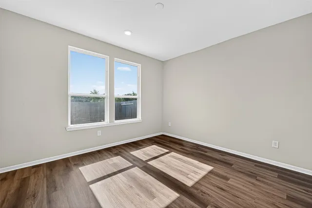 a view of wooden floor in an empty room
