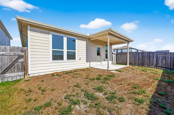 a view of backyard with wooden fence