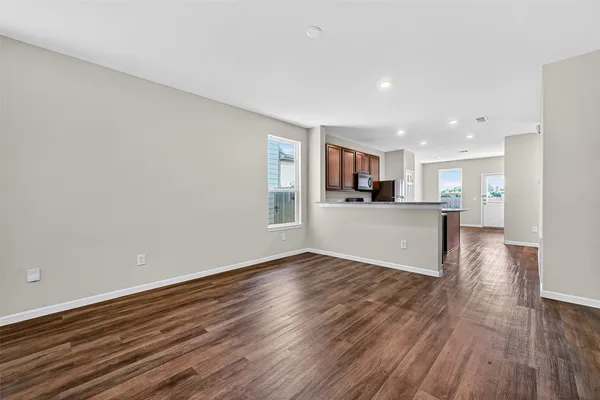 a view of a kitchen with wooden floor and a kitchen