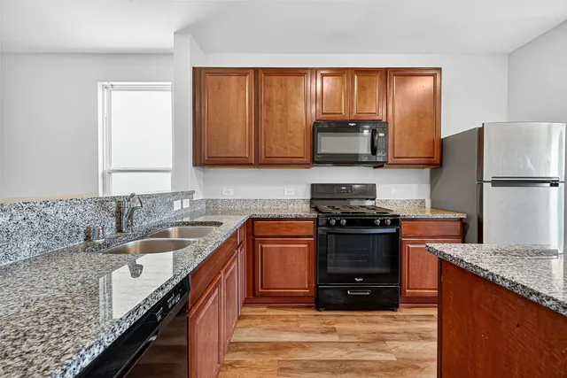 a kitchen with a stove a sink and a microwave