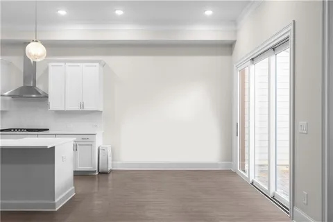 a kitchen with white cabinets and a stove