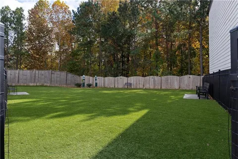 a view of garden with trees in the background
