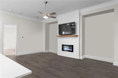 a view of an empty room with wooden floor a fireplace and a window