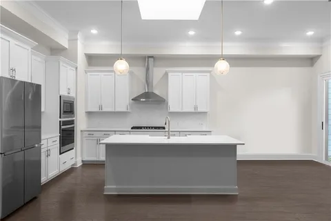 a kitchen with kitchen island a counter top a stove a sink and a refrigerator