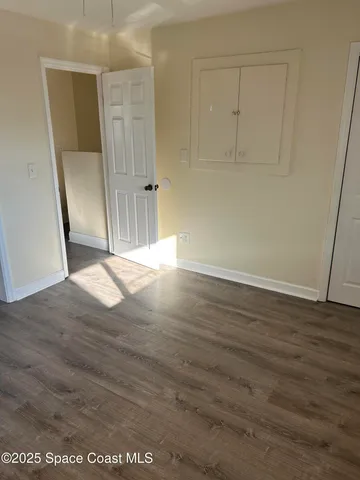 an empty room with wooden floor