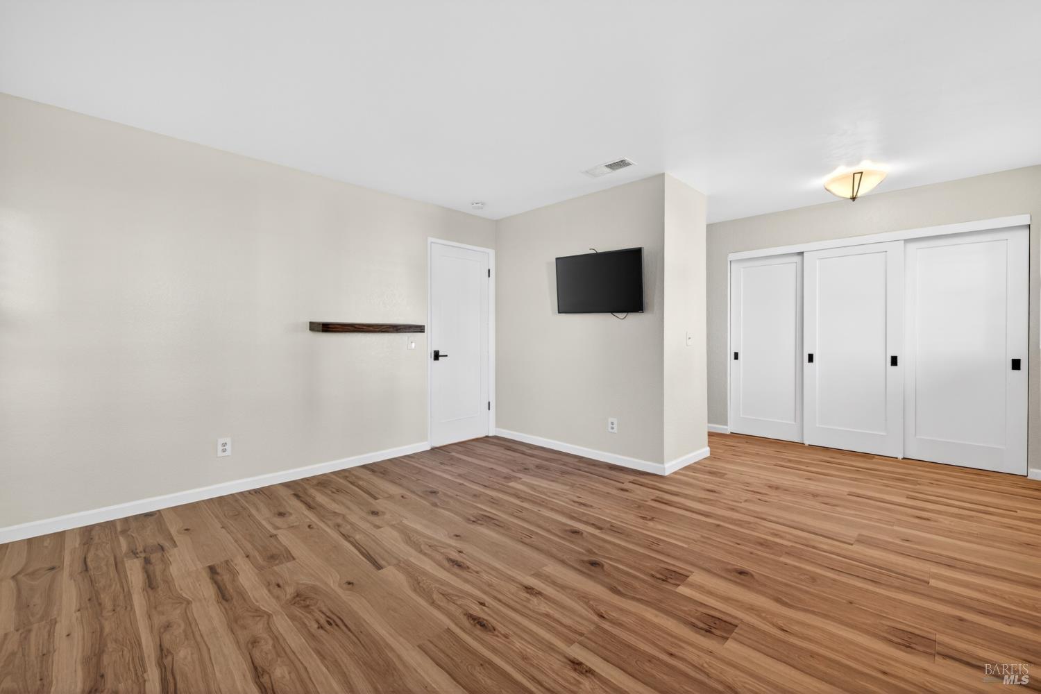 2757 Lakeview Drive Santa Rosa, CA 95405 - Photo 18 of 54 a view of an empty room with wooden floor