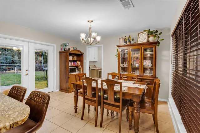 a view of a dining room with furniture wooden floor and chandelier