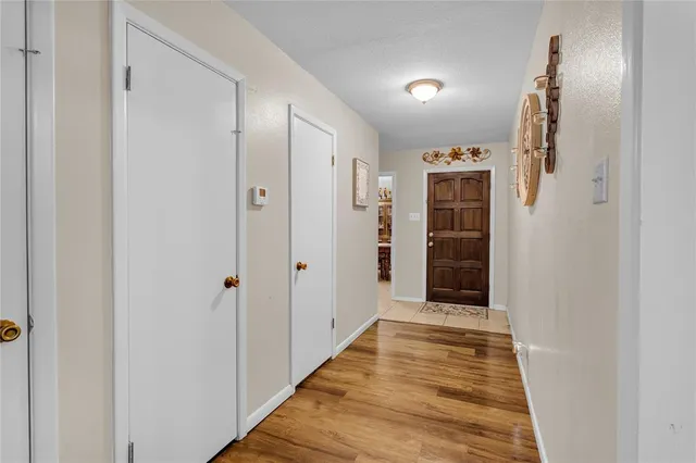 a view of a hallway with wooden shelves
