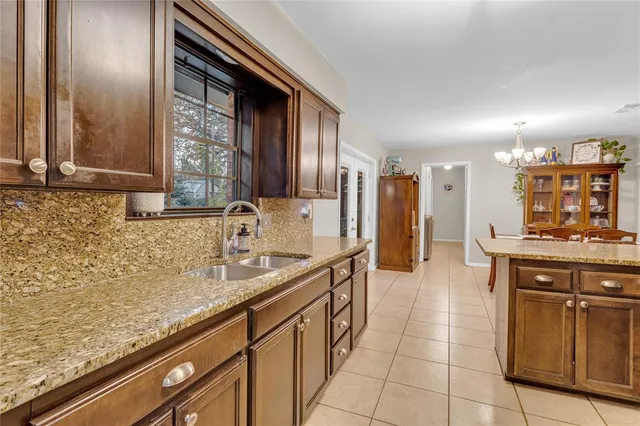 a kitchen with stainless steel appliances granite countertop a sink and cabinets