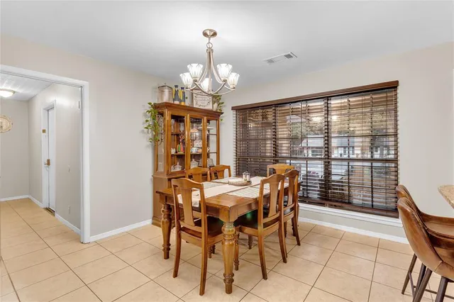 a view of a dining room with furniture wooden floor and chandelier