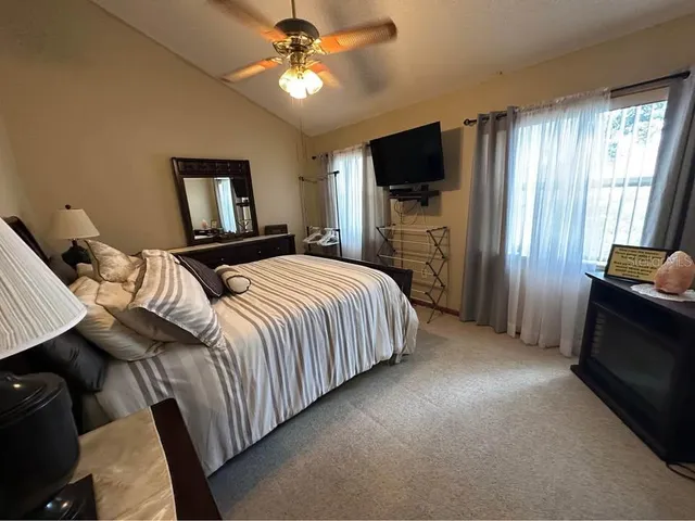 a bedroom with a bed and a flat screen tv