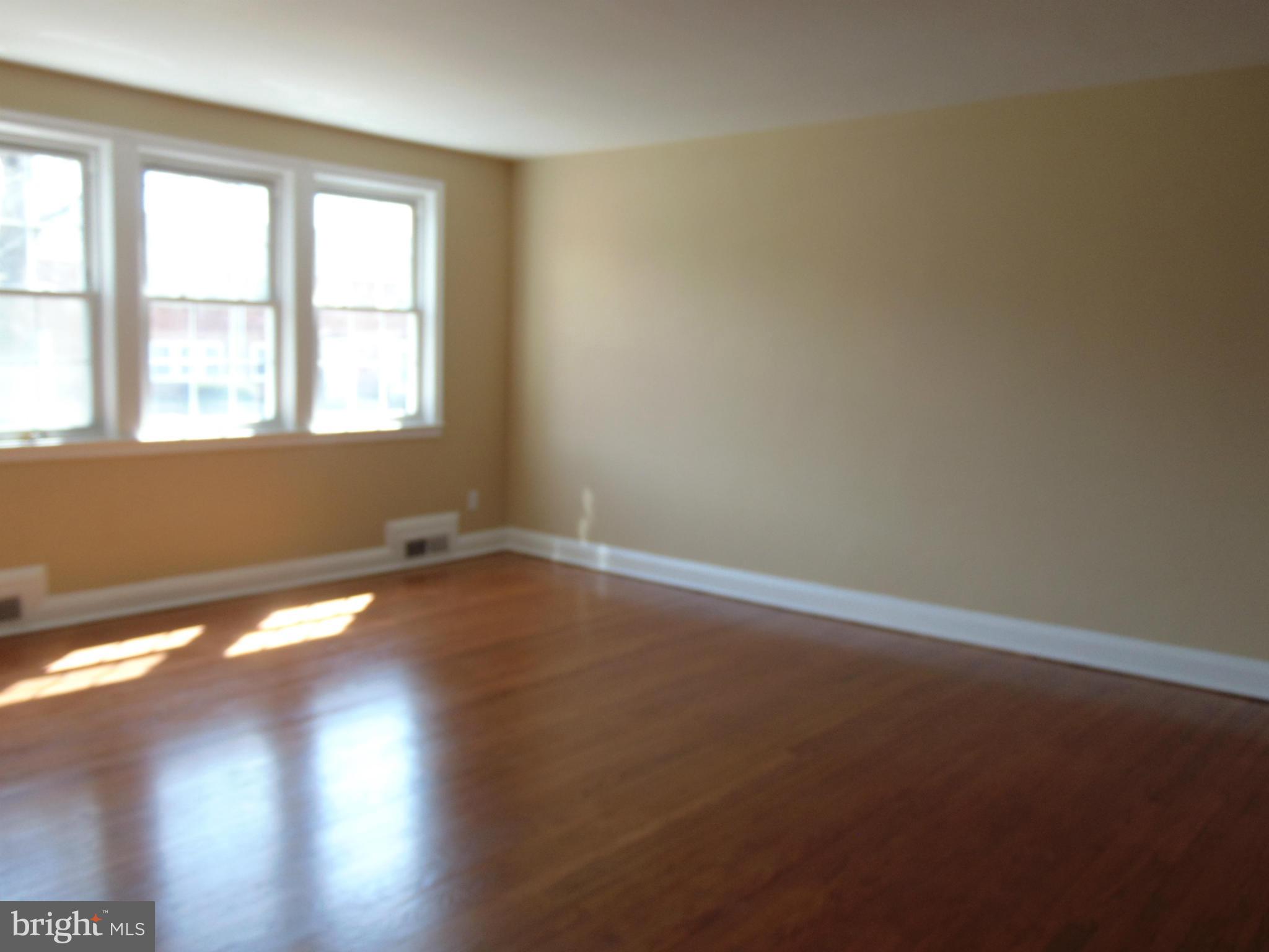 1827 Deveron Road Baltimore, MD 21286 - Photo 3 of 15 an empty room with wooden floor and windows