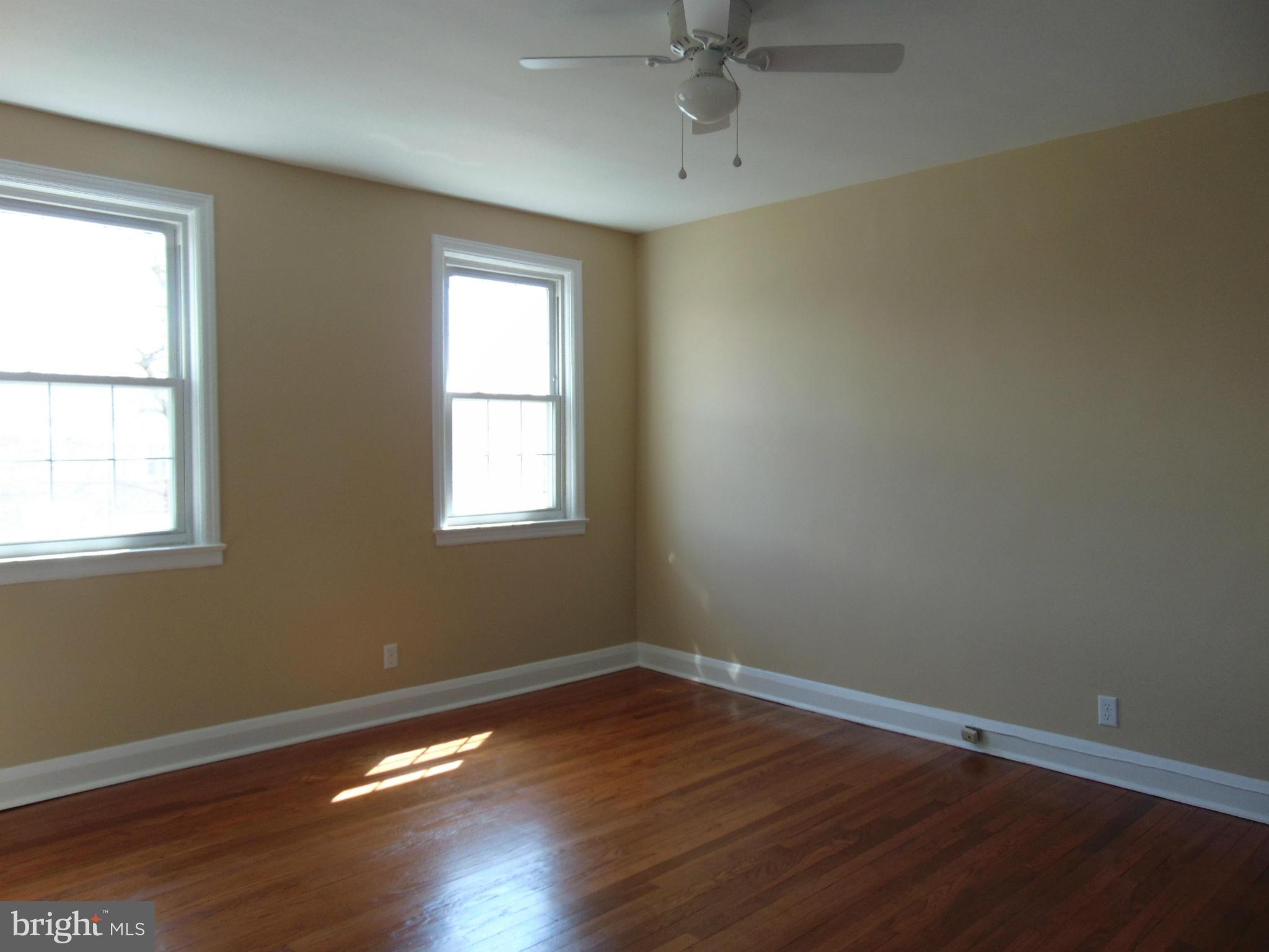 1827 Deveron Road Baltimore, MD 21286 - Photo 8 of 15 a view of an empty room with wooden floor and a window