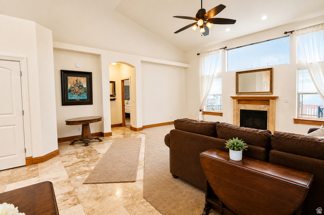 1055 North 1000 East Mapleton, UT 84664 - Photo 21 of 112 Vaulted ceilings and expansive windows frame the living area, featuring a fireplace with a stone surround and wood mantel