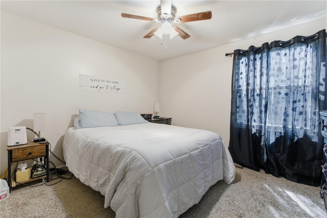 707 West Martindale Road Union, OH 45322 - Photo 14 of 28 This cozy bedroom features a ceiling fan, plush carpet flooring, and ample natural light.