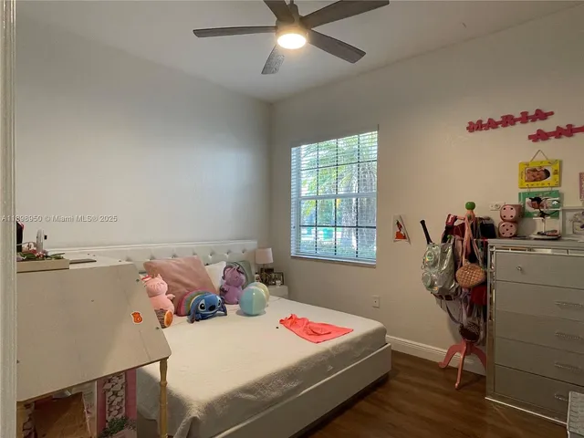 a bedroom with two beds and a chandelier