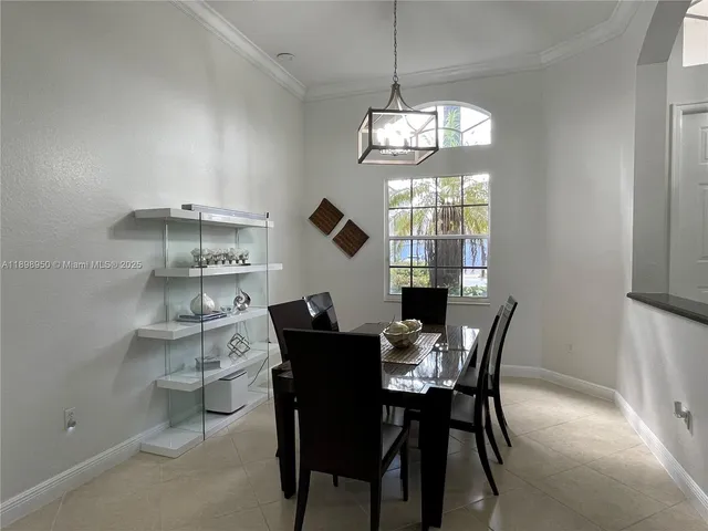 a view of a dining room with furniture a chandelier and wooden floor
