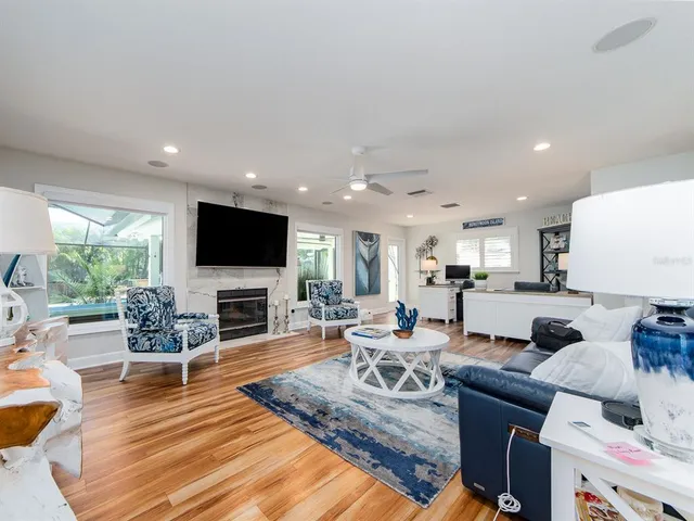 a view of a patio with a dining table chairs and backyard