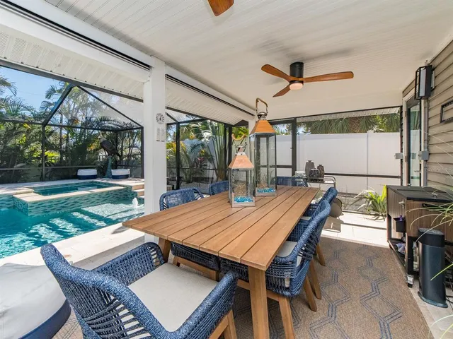 a view of a dining room with furniture wooden floor and chandelier