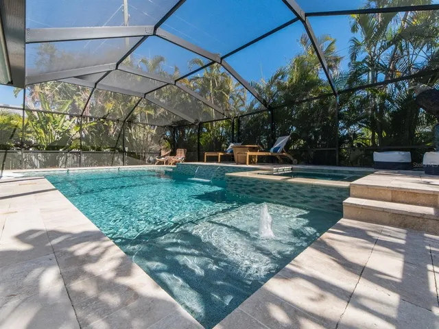a spacious bedroom with a bed painting on wall and windows