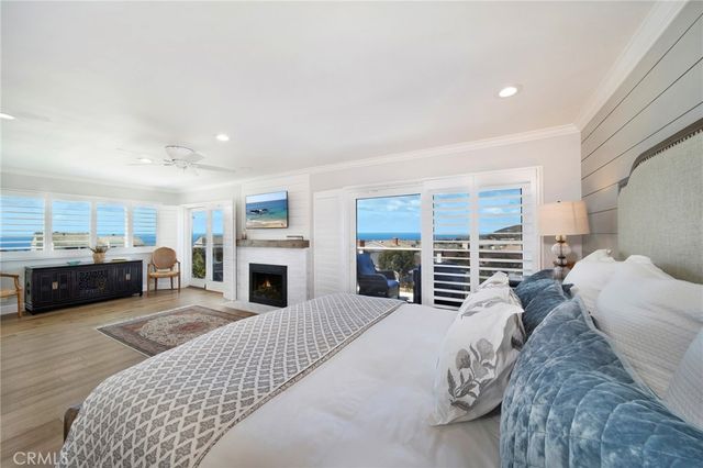 a living room with furniture a fireplace a flat screen tv and kitchen view