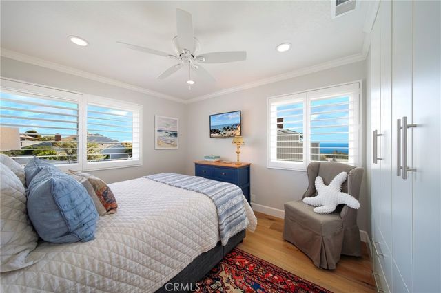 a bedroom with a bed and large window