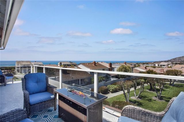 a view of roof deck with couches and potted plants