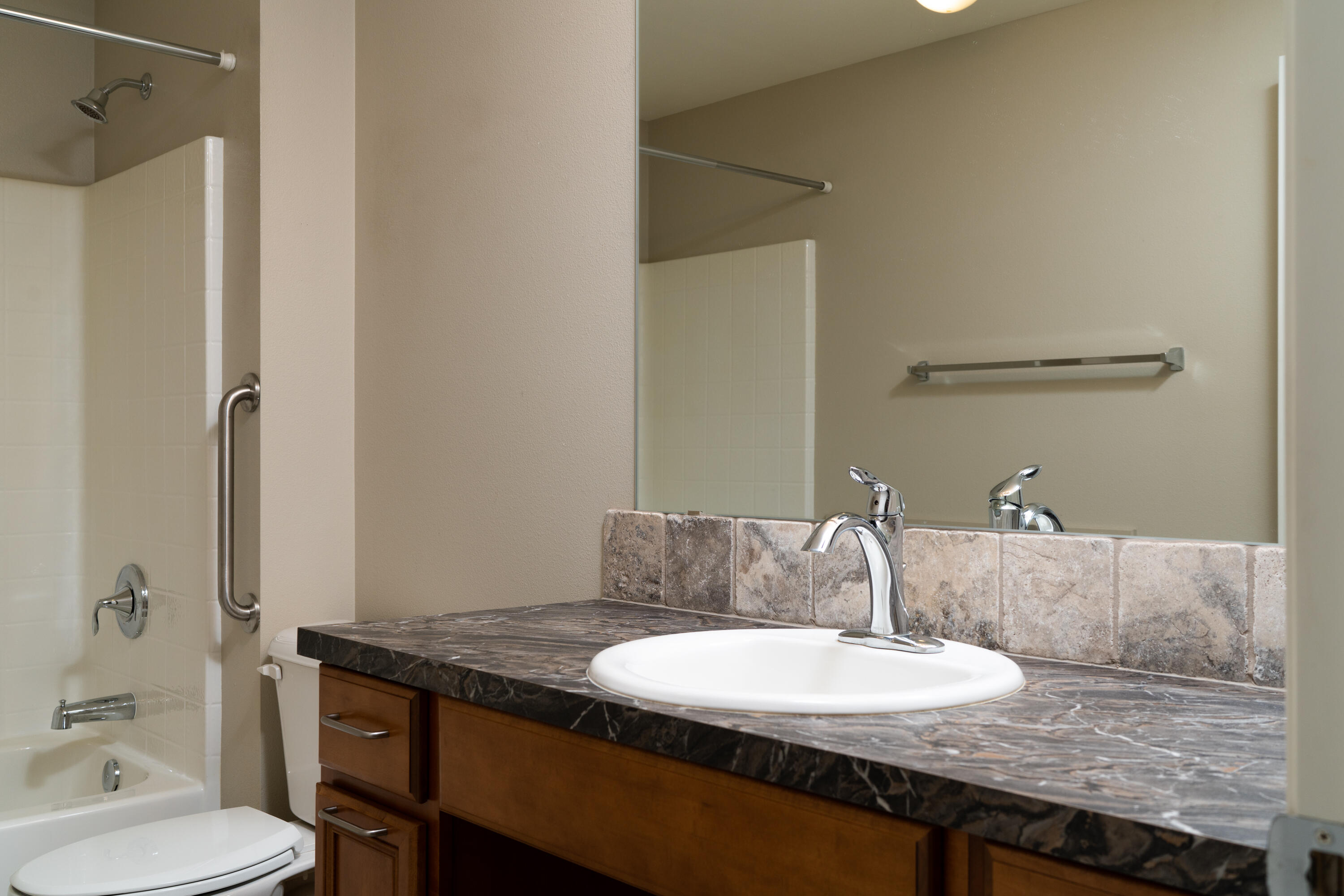70099 Indian Ford Road Sisters, OR 97759 - Photo 22 of 27 a bathroom with a granite countertop sink a toilet and a mirror