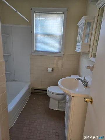 a bathroom with a sink a toilet and bathtub