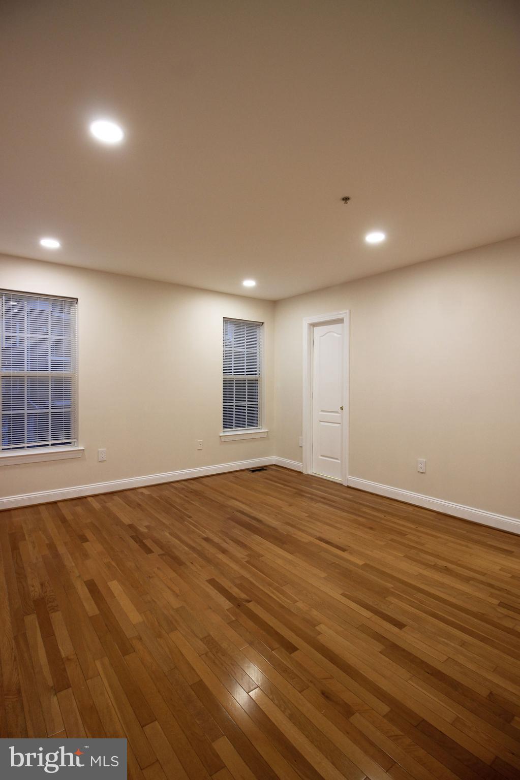 141 Chevy Chase Street, Unit 141 Gaithersburg, MD 20878 - Photo 21 of 32 a view of an empty room with wooden floor and a window