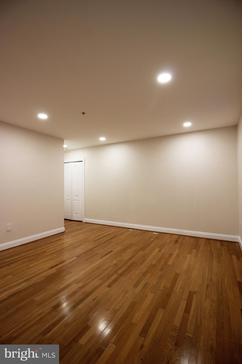 141 Chevy Chase Street, Unit 141 Gaithersburg, MD 20878 - Photo 22 of 32 an empty room with wooden floor and windows