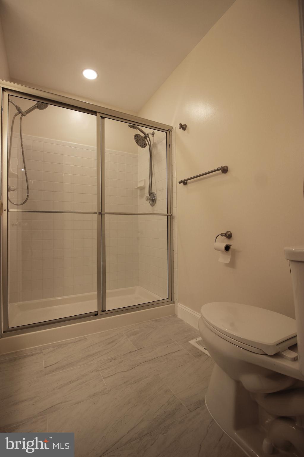 141 Chevy Chase Street, Unit 141 Gaithersburg, MD 20878 - Photo 25 of 32 a bathroom with a toilet and a shower