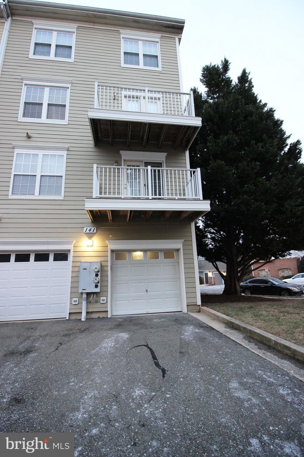 141 Chevy Chase Street, Unit 141 Gaithersburg, MD 20878 - Photo 27 of 32 a view of a house with a yard and garage