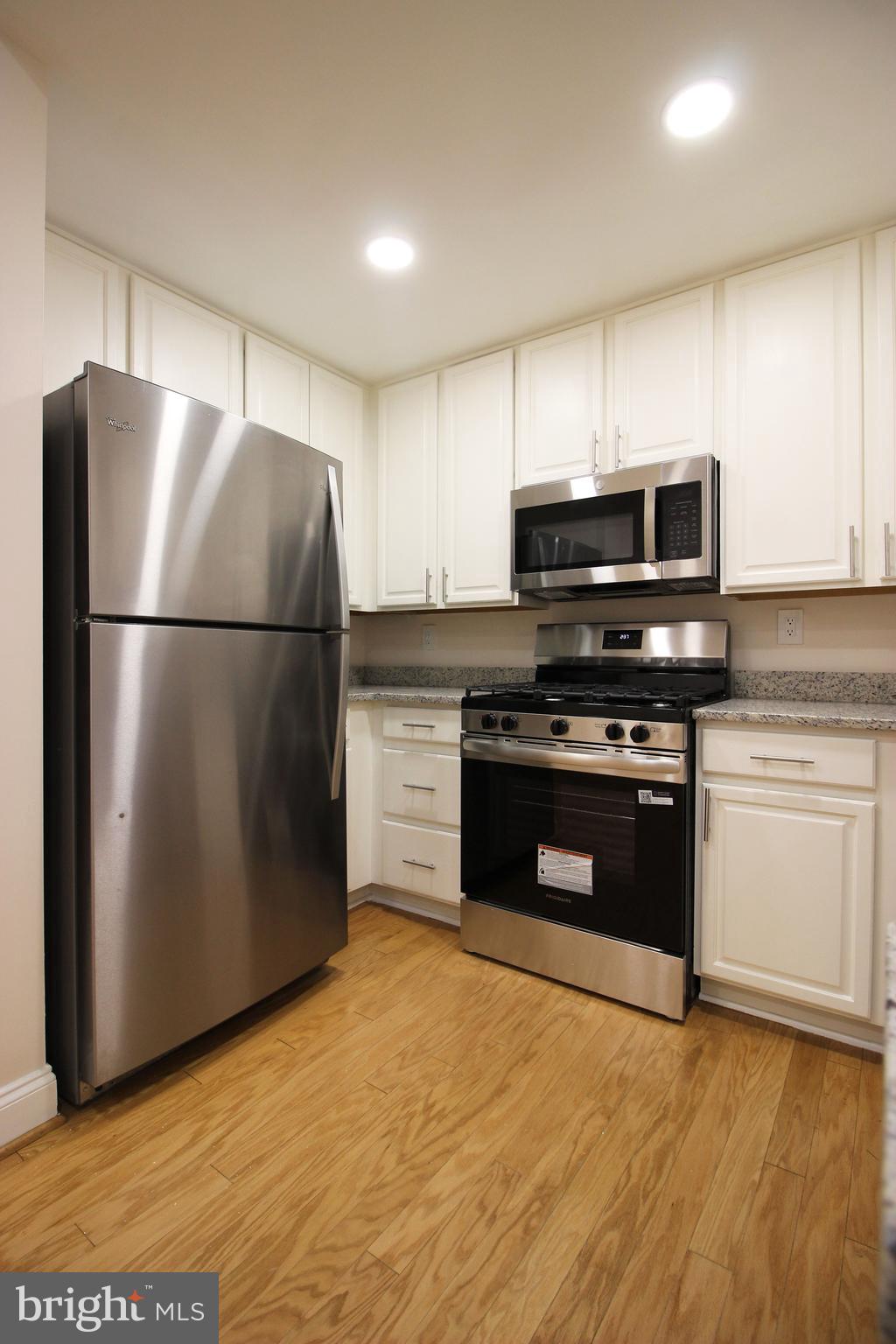 141 Chevy Chase Street, Unit 141 Gaithersburg, MD 20878 - Photo 8 of 32 a kitchen with a refrigerator and a stove
