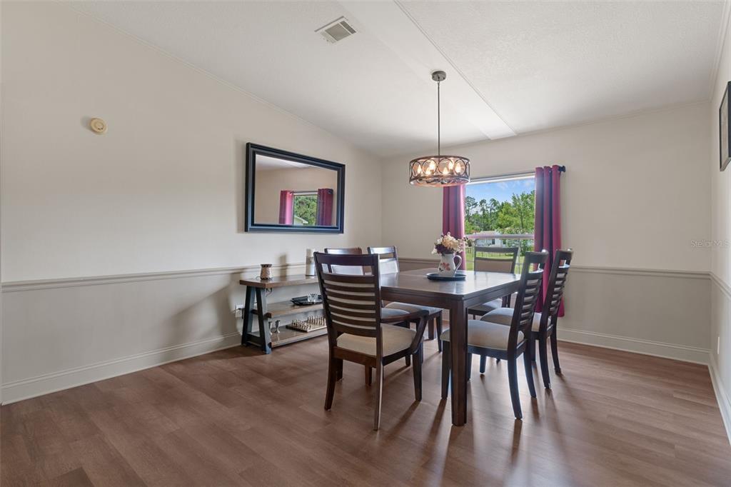 26255 Lambeth Road Brooksville, FL 34601 - Photo 16 of 76 a view of a dining room with furniture window and wooden floor