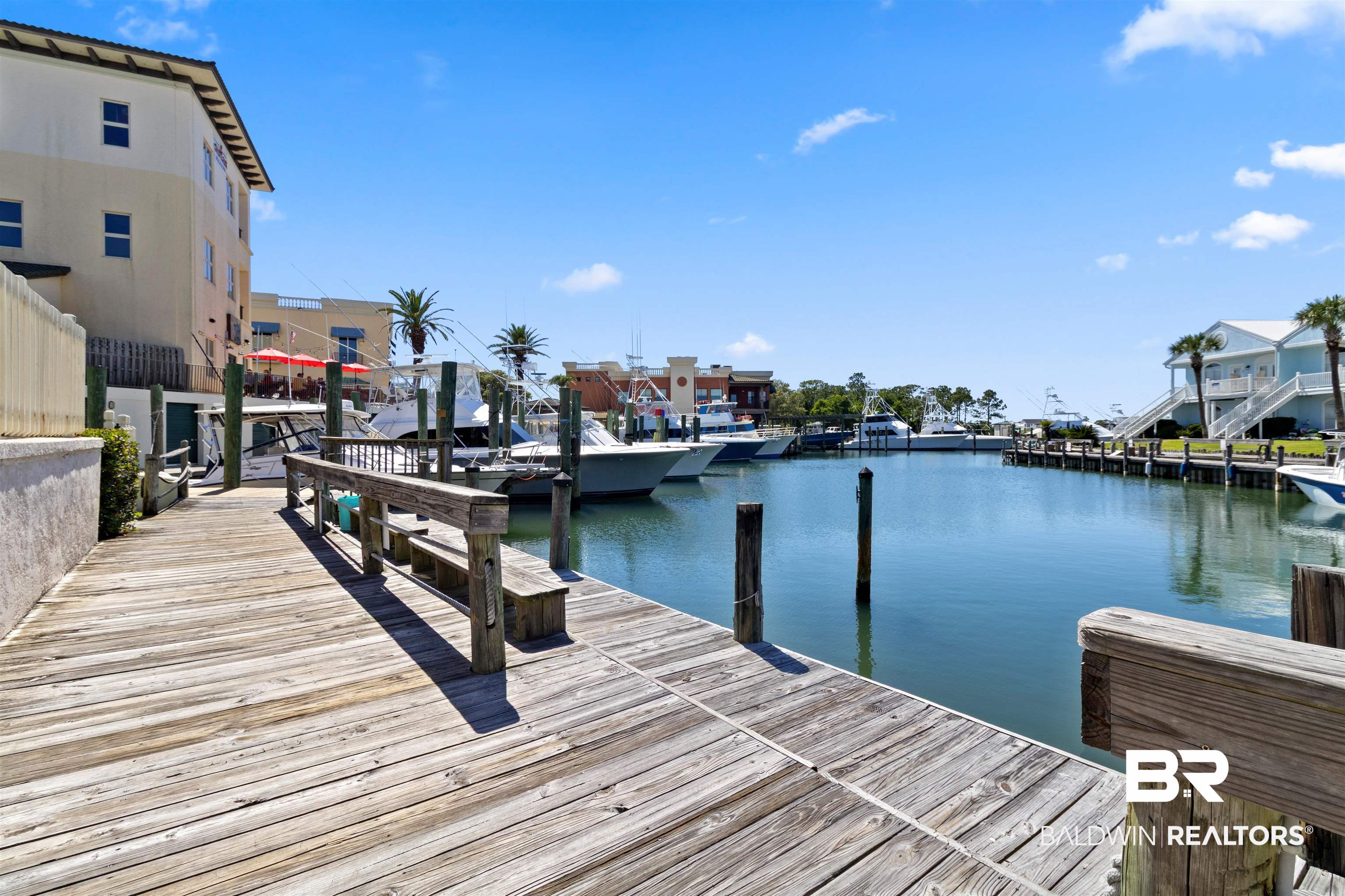 3543 Bayou Road, Unit 5 Orange Beach, AL 36561 - Photo 26 of 33 Expansive waterfront dock with weathered wood planks and integrated seating