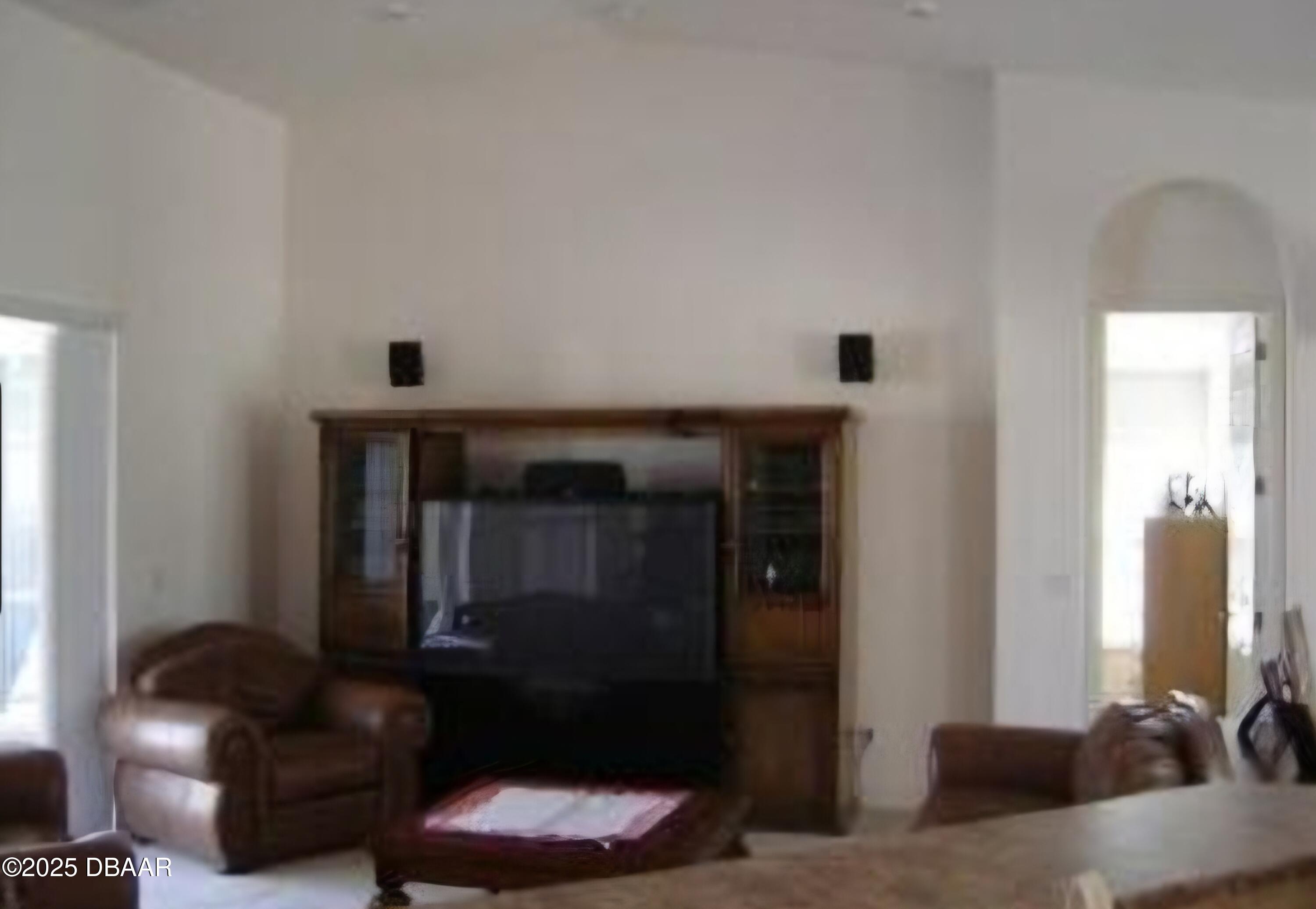 4 Waterbluff Drive Ormond Beach, FL 32174 - Photo 5 of 7 a living room with furniture and a fireplace