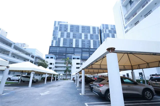 a view of a patio with table and chairs under an umbrella