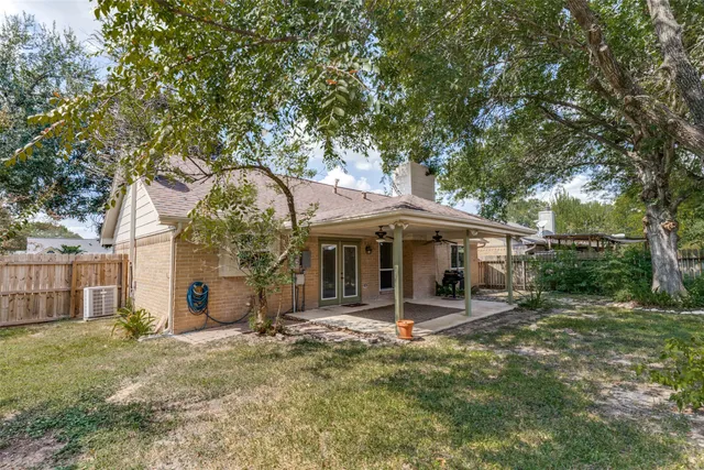 a backyard of a house with barbeque oven